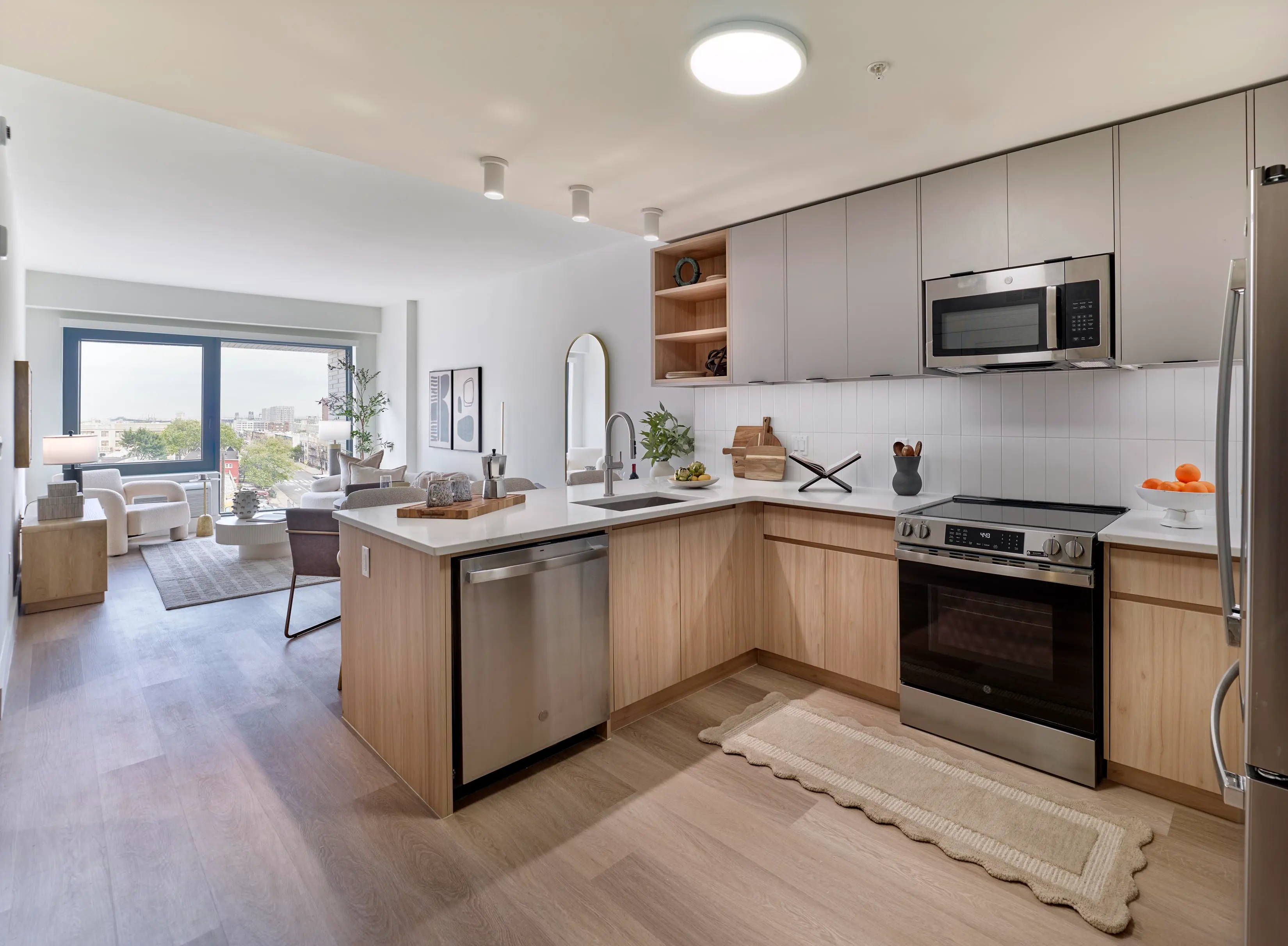 Contemporary apartment kitchen with wooden cabinetry and open layout